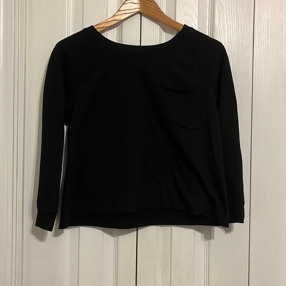 Black long sleeve shirt with one breast pocket.